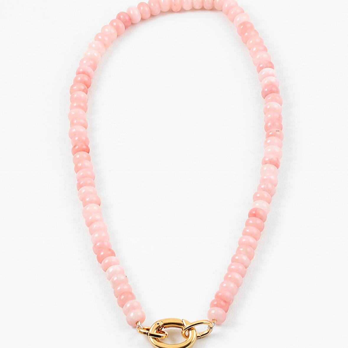 Light pink bead necklace with large gold carabiner clasp.