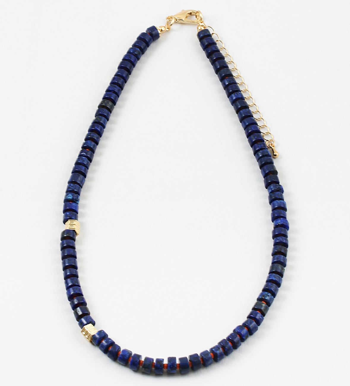 Navy bead necklace with two gold accent spacers beads.