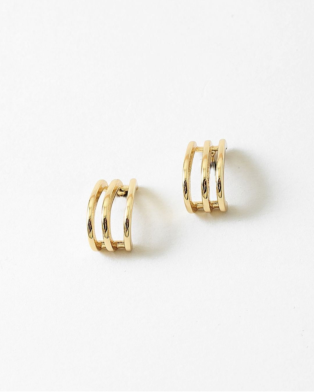 Pair of gold hoop earrings on a white background