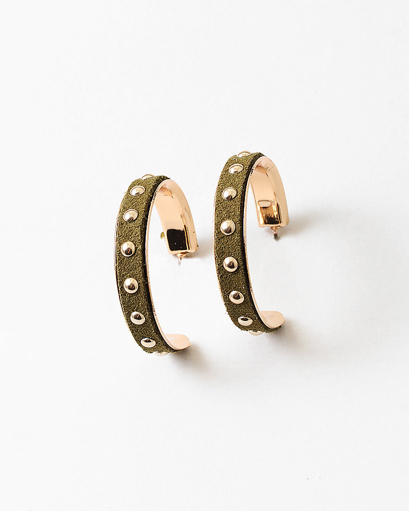 Green suede gold hoop earrings with studded details on a white background