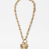 Picture of gold toggle chain with a large gold heart pendant with a diamond at its center.
