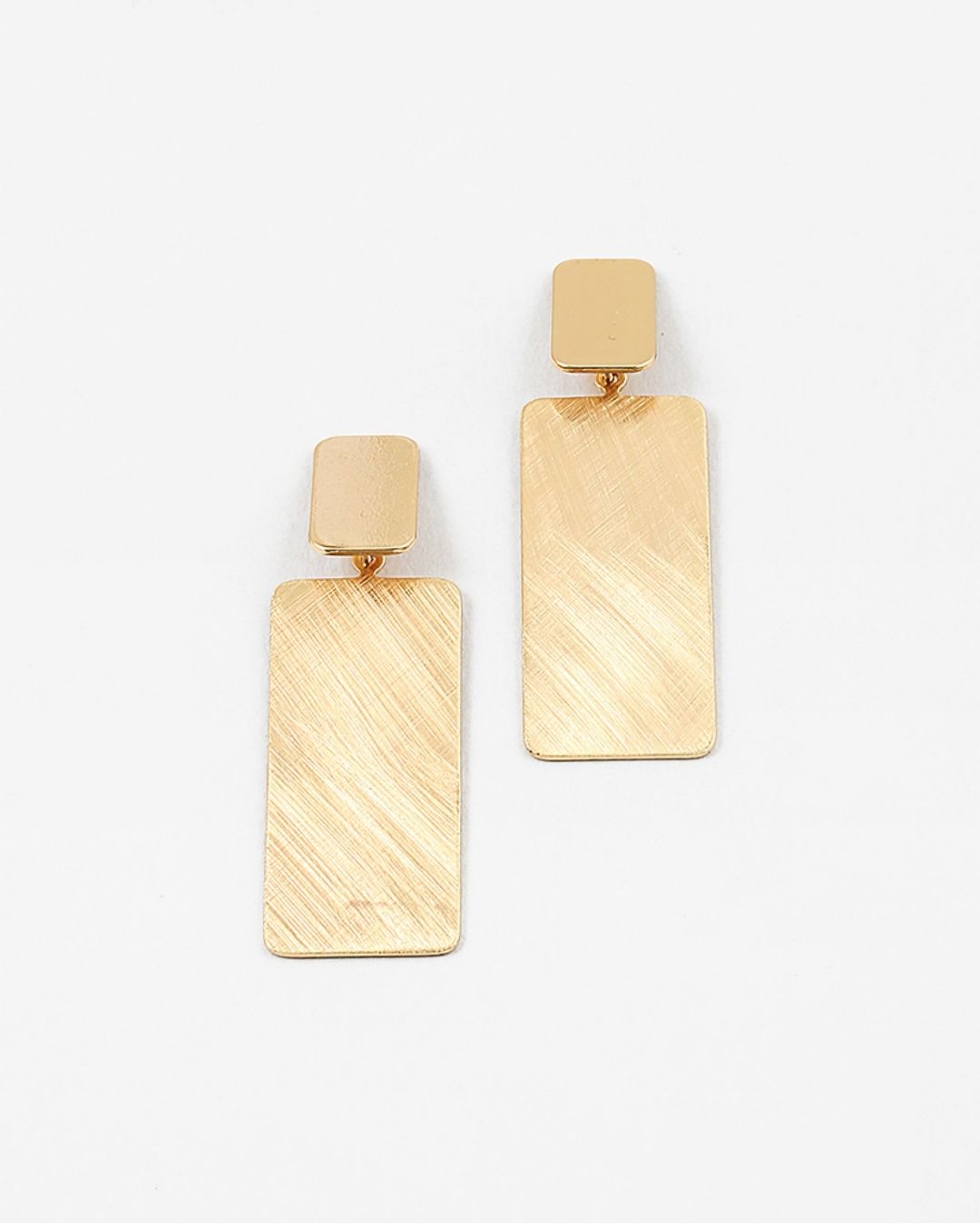 Large brushed gold rectangular earrings on a white background