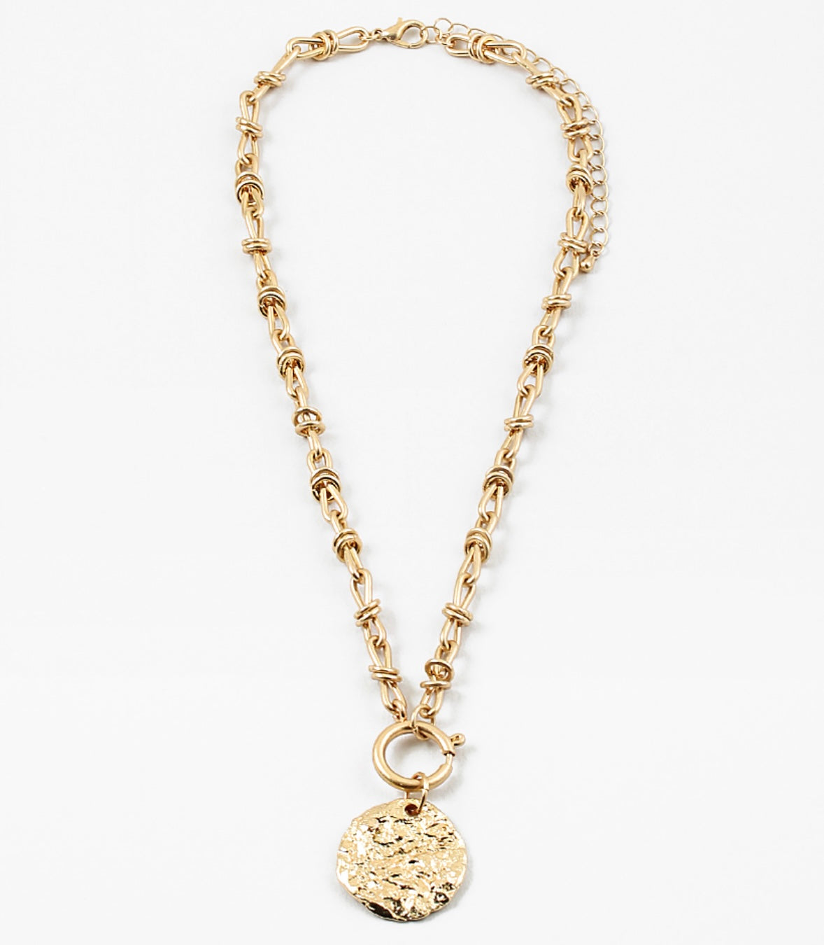 Gold toggle chain necklace with a large hammered disc pendant.