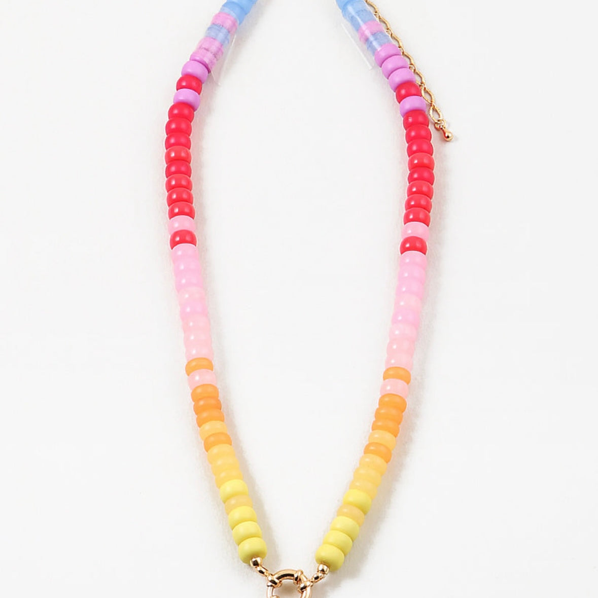 Necklace with colorful purple, pink and yellow toned beads on a white background