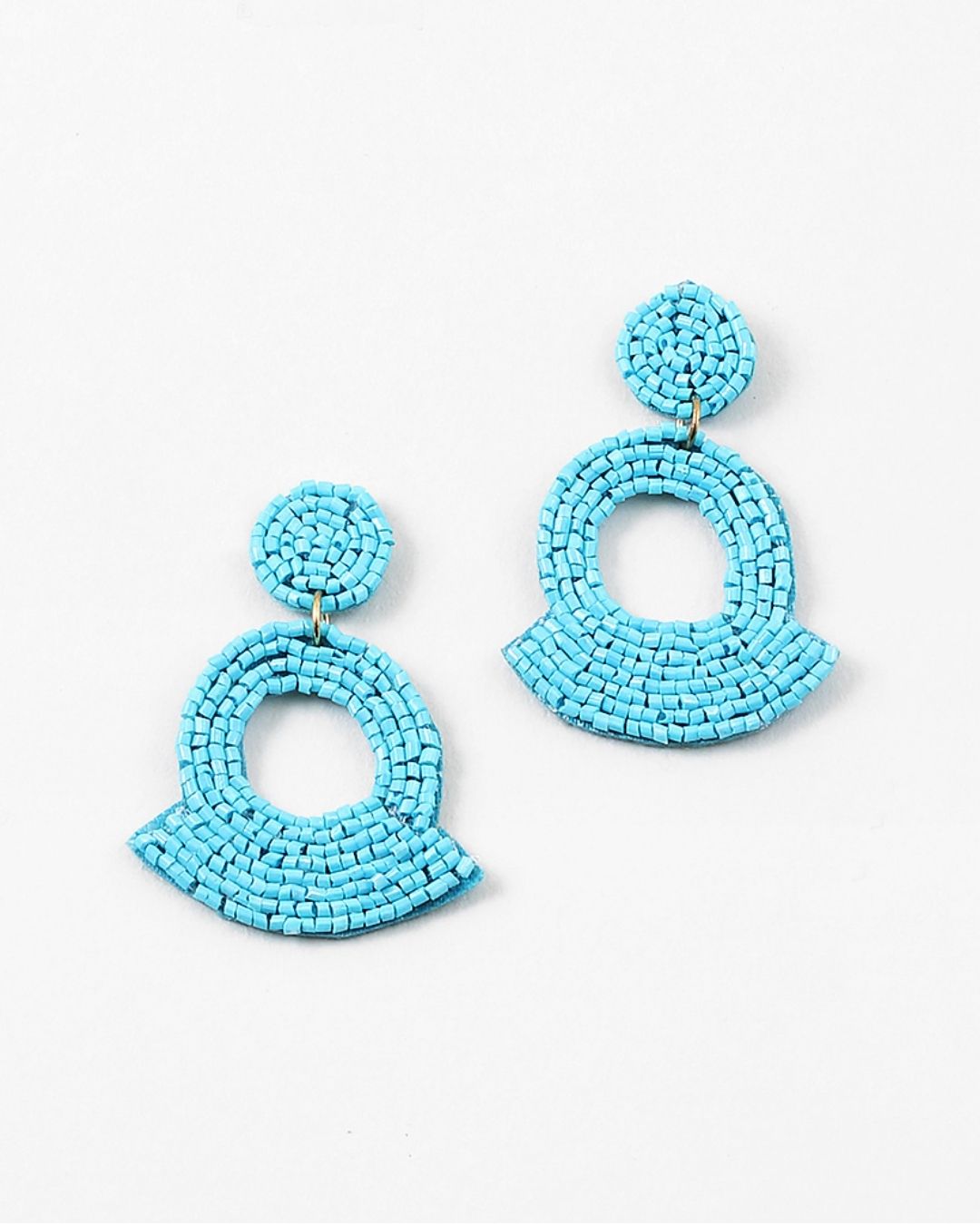 Large turquoise beaded statement earrings on a white background