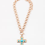 Large circle link gold chain with a toggle clasp. Necklace has a gold Cross with turquoise beads set in it as a pendant.