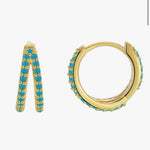 Gold hoop earrings with turquoise stones on a white background