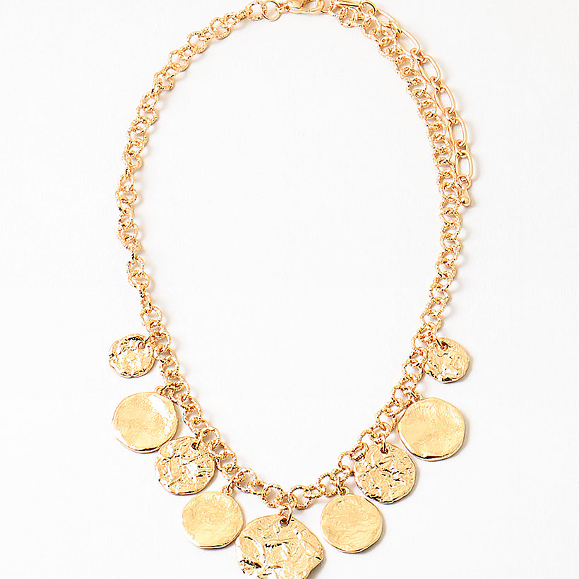 Picture of gold chain with nine hammered gold disc pendants.