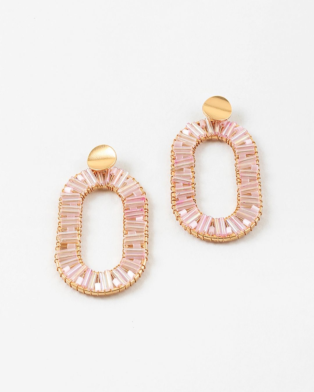Pair of large oval pink beaded earrings with gold accents on a white background