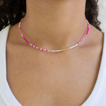 Dainty seed bead necklace made of white and pink beads with gold spacer beads