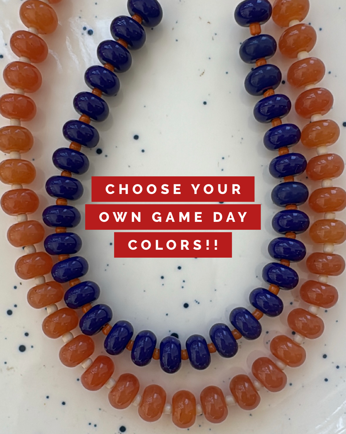 Necklaces with blue and orange beads on a white background with text 'Choose Your Own Game Day Colors!!'.