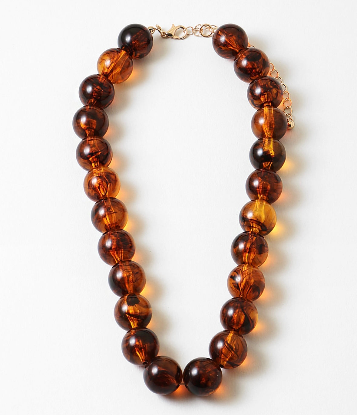 Brown beaded necklace on a white background