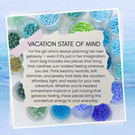 Product packaging with colorful blue toned beads and text about a 'Vacation State of Mind' product.