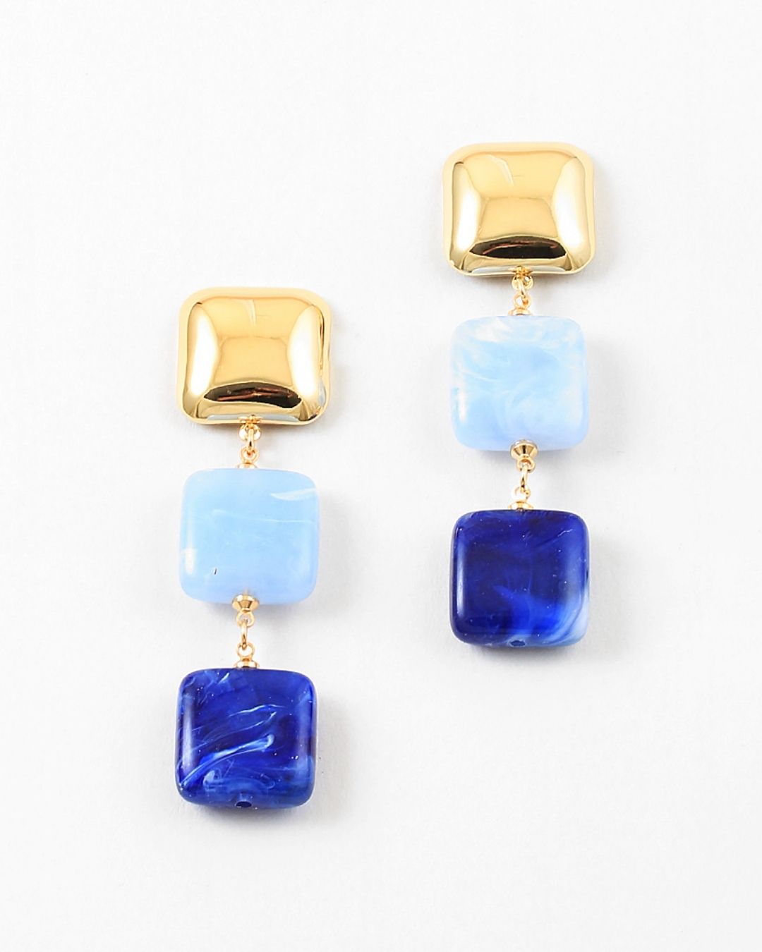 Gold and blue square bead dangle earrings on a white background