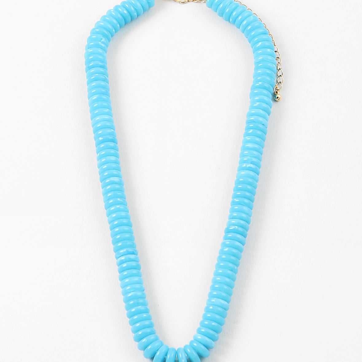 Blue beaded necklace on a white background