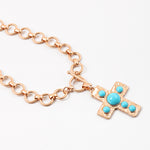 Large circle link gold chain with a toggle clasp. Necklace has a gold Cross with turquoise beads set in it as a pendant.