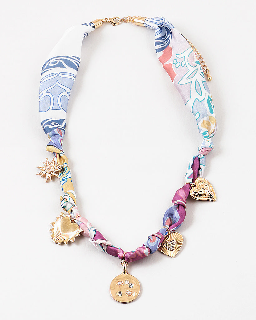 Colorful fabric necklace with gold charms on a white background