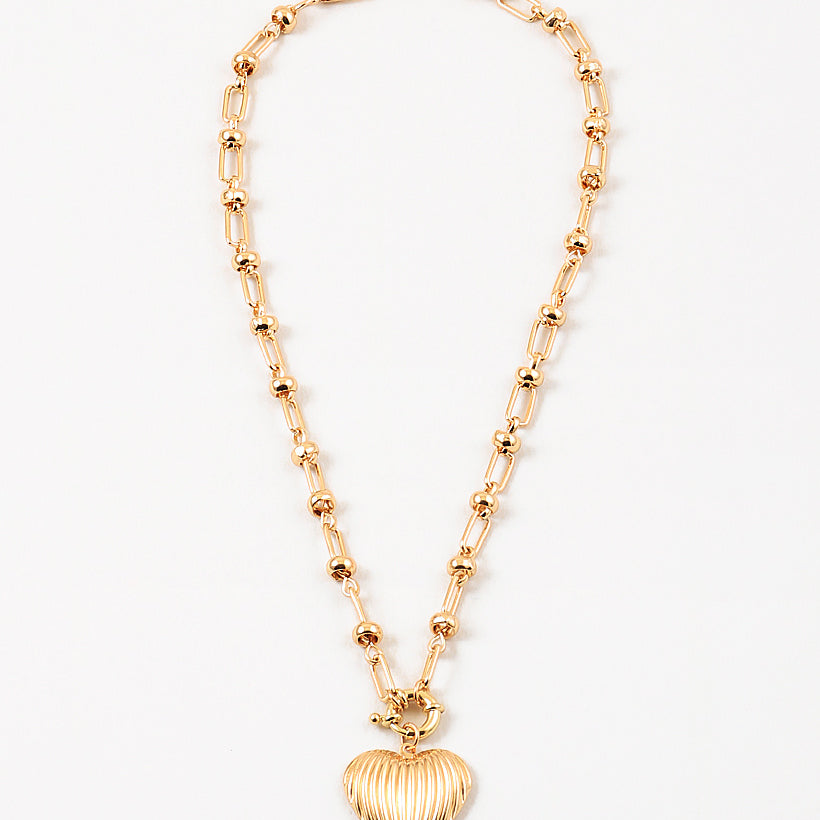 Gold necklace with a heart-shaped pendant on a white background