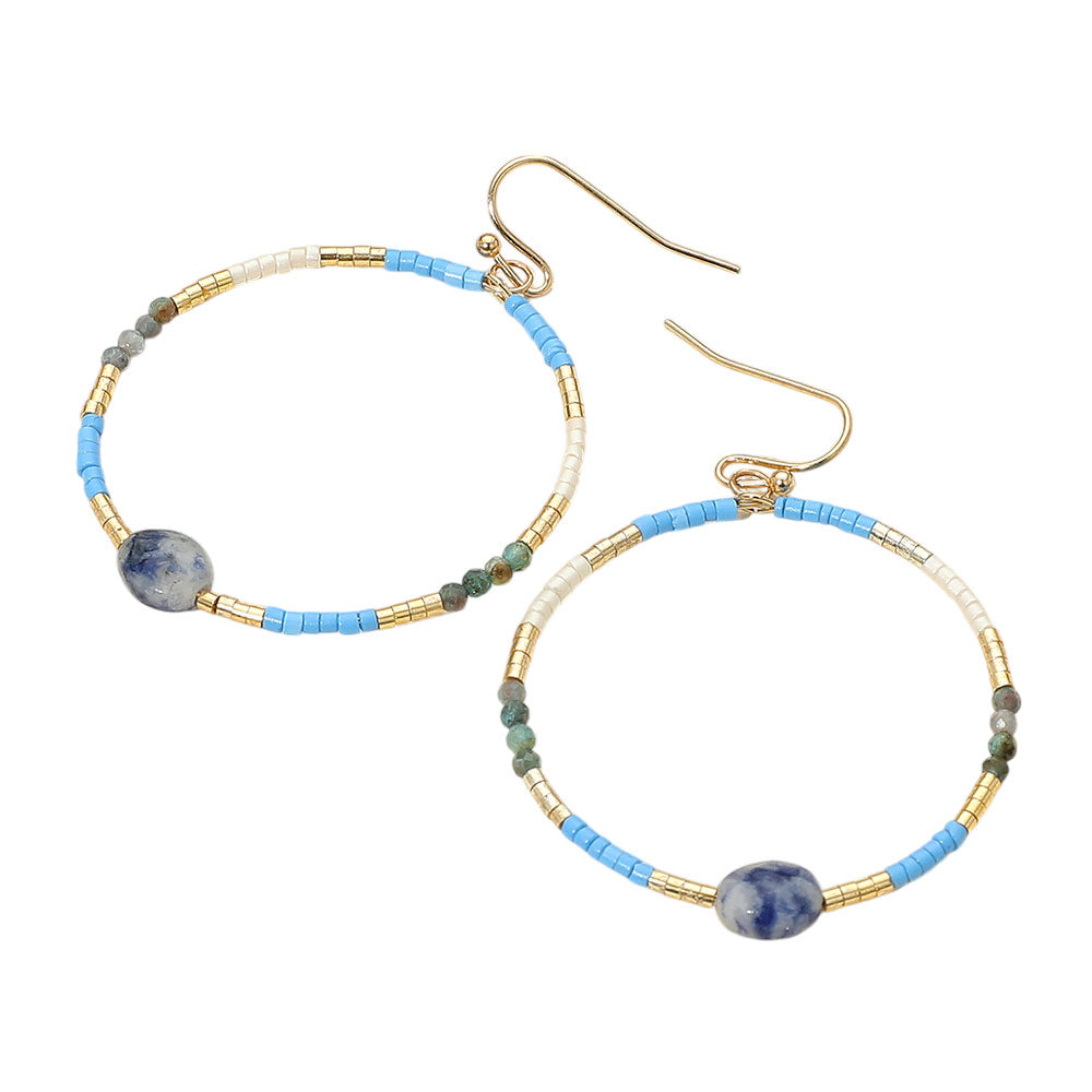 Pair of hoop earrings with blue and gold beads on a white background
