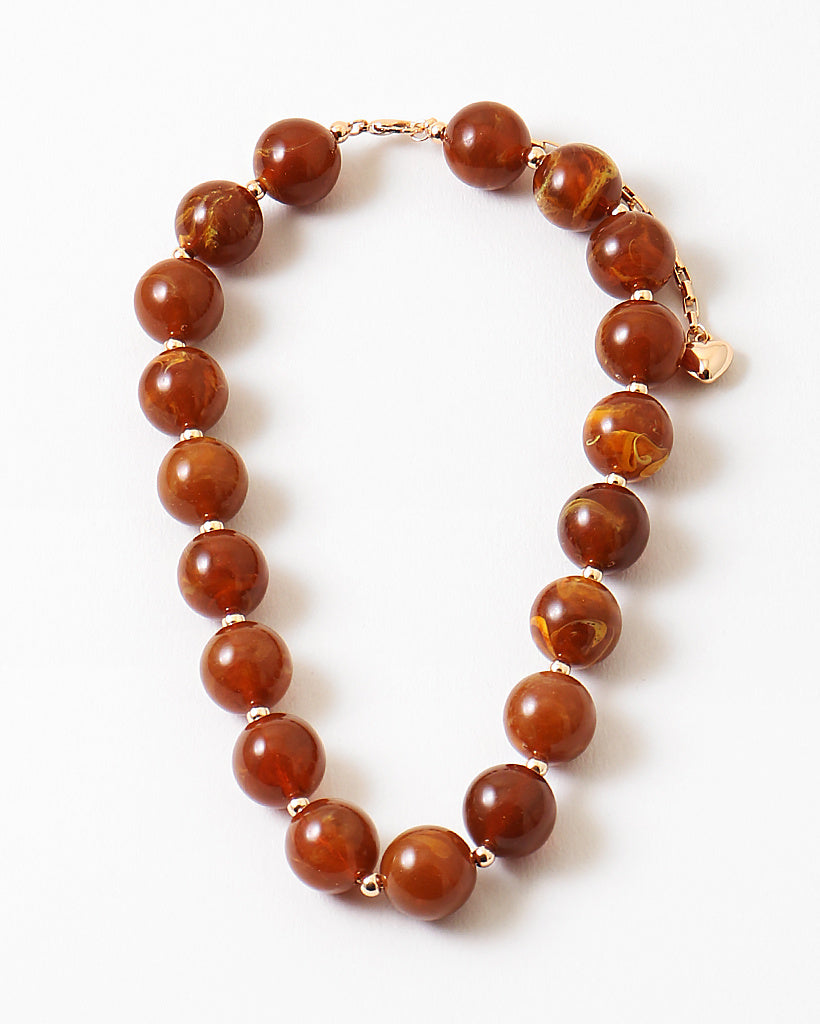 Chunky rust orange bead necklace.