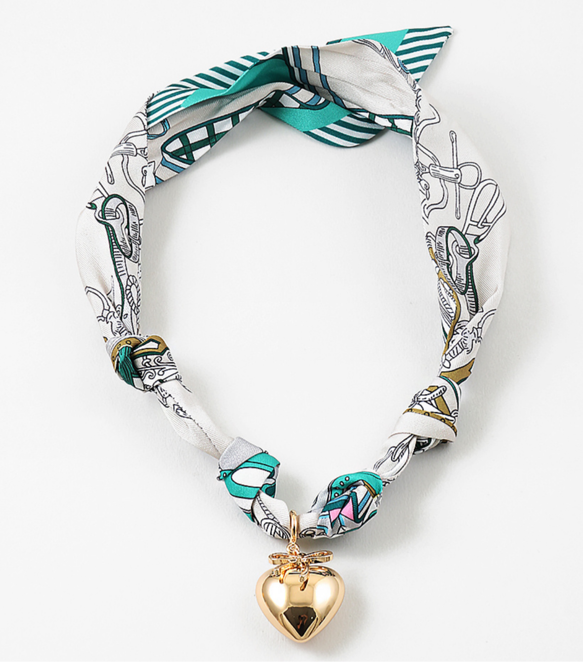 Necklace with a heart-shaped pendant and decorative scarf on a white background