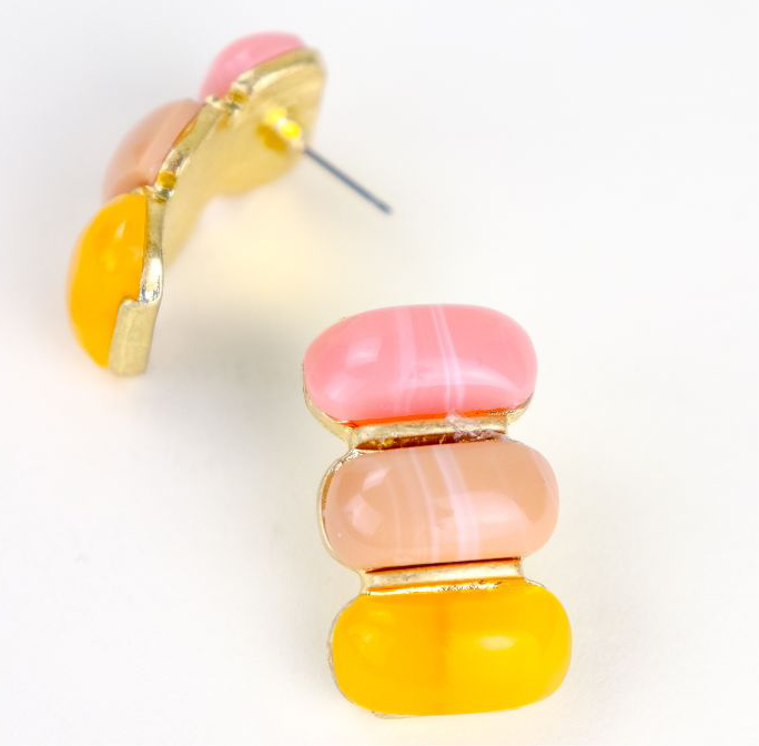 Colorful yellow and pink layered earring on a white background