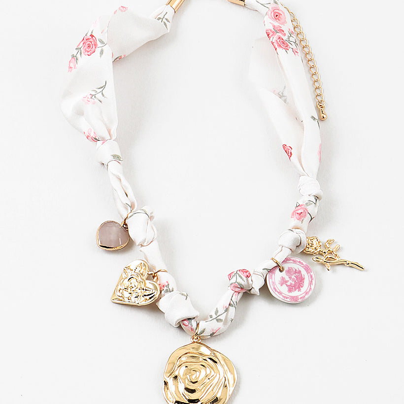 Decorative scarf necklace with floral and heart charms on a white background
