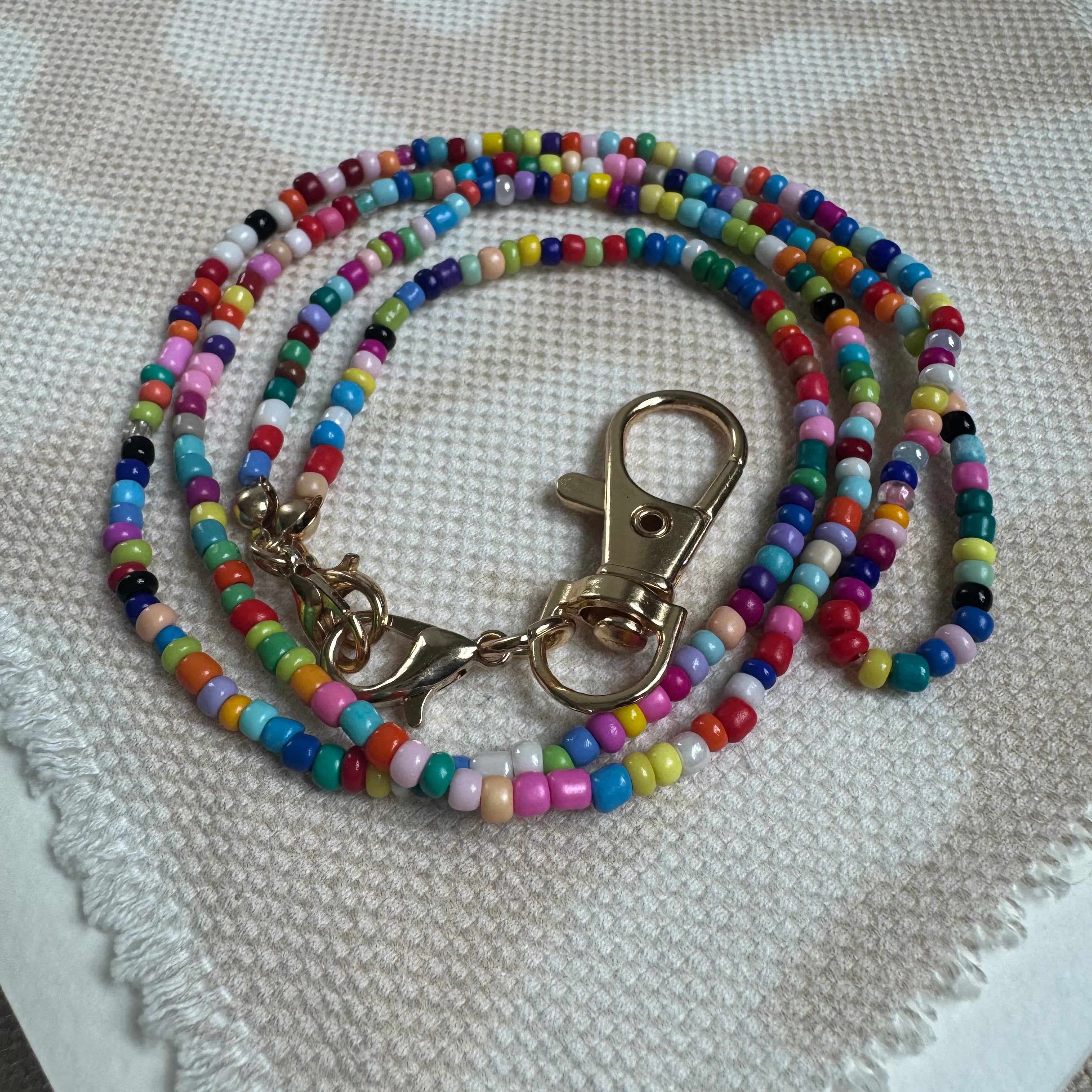 Picture of a multicolored beaded lanyard with a gold clasp.