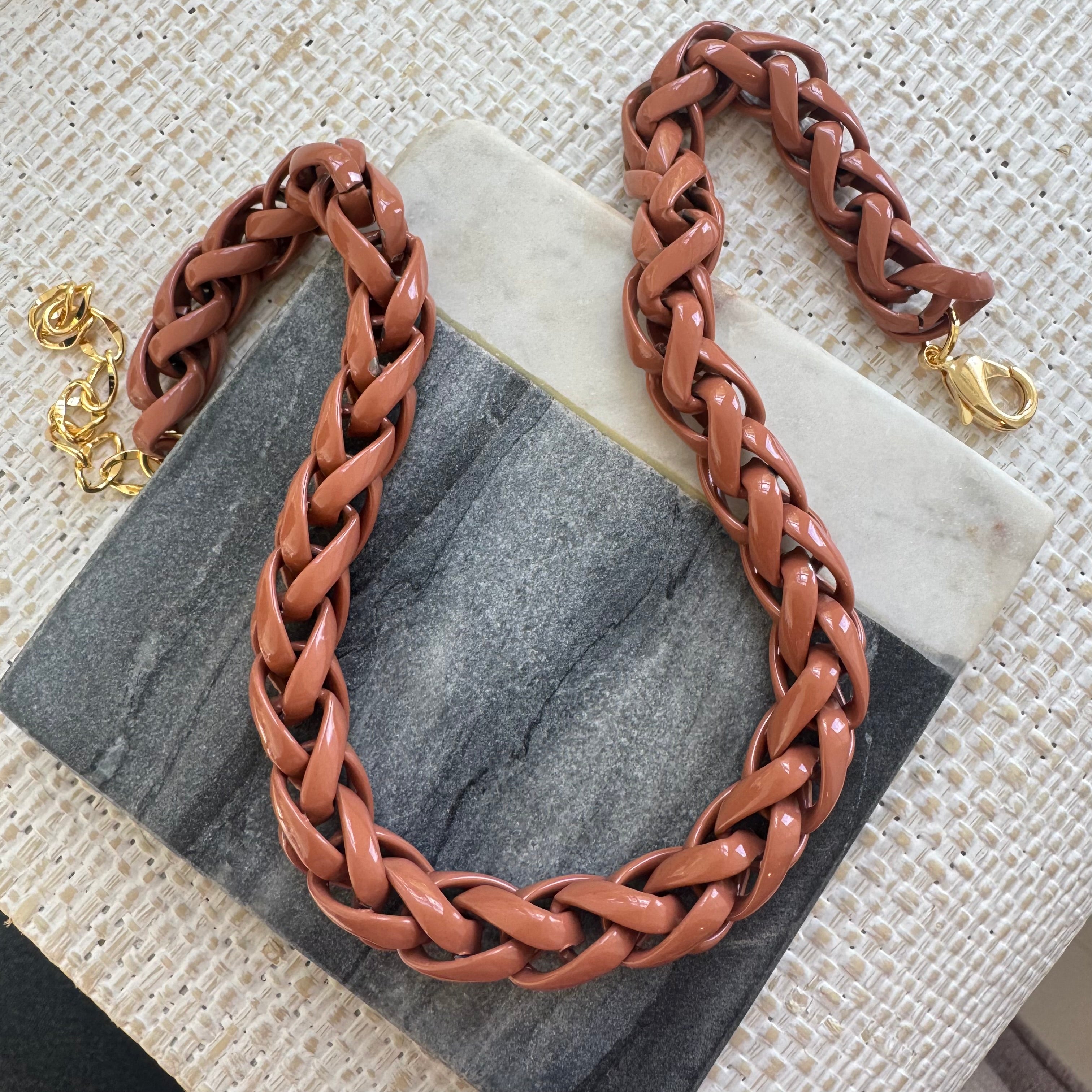 Brown braided necklace on a marble surface