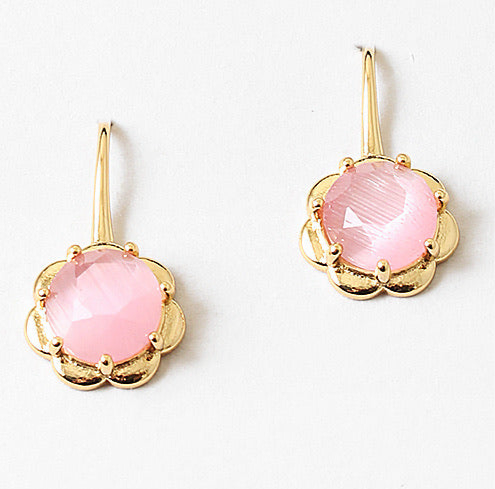 Gold flower earrings with pink stones on a white background