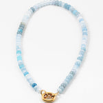Necklace with light blue and white beads and a gold clasp on a white background