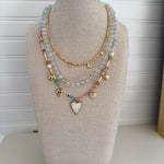 Necklace with heart-shaped charm on a mannequin bust against a white background