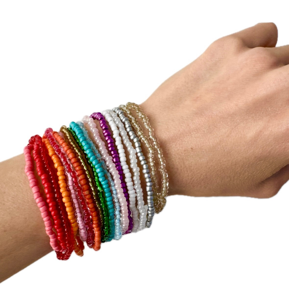 Hand wearing multiple colorful beaded bracelets on a white background