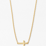 Gold cross necklace on a white background