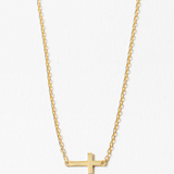 Gold cross necklace on a white background