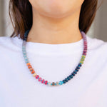 Girl wearing a multi-colored beaded short necklace around her neck