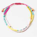 Bracelet made of double strands of beads in pinks, teals, whites and yellows.