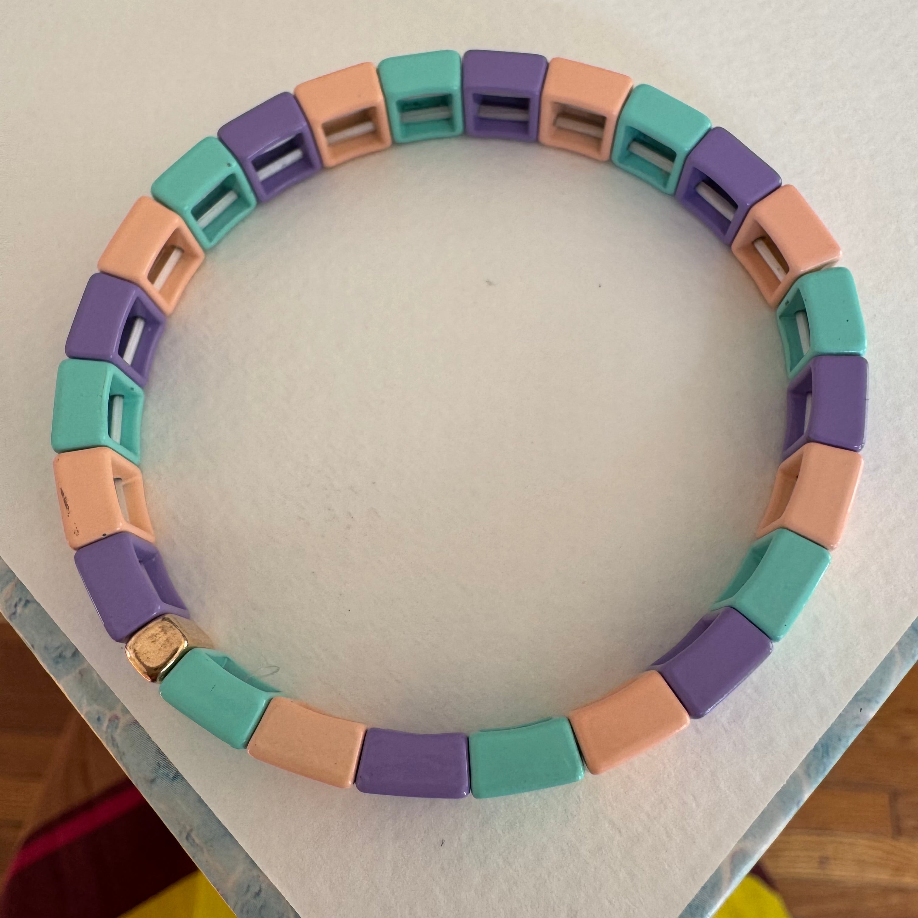 Square bead bracelet in coral, teal and lavender.