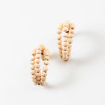 Picture of a three strand hoop earrings threaded through small wooden beads.
