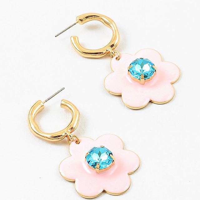 Small gold hoop earrings with large pink flowers dangling down with a light blue stone center.