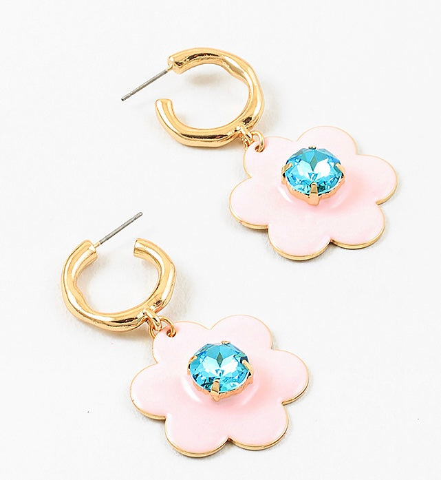Small gold hoop earrings with large pink flowers dangling down with a light blue stone center.