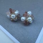 Set of stud earrings made of a cluster of light purple stones and freshwater pearls.