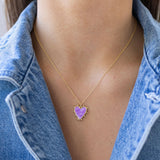 Picture of a fine gold chain with a purple heart pendant with gold edging.