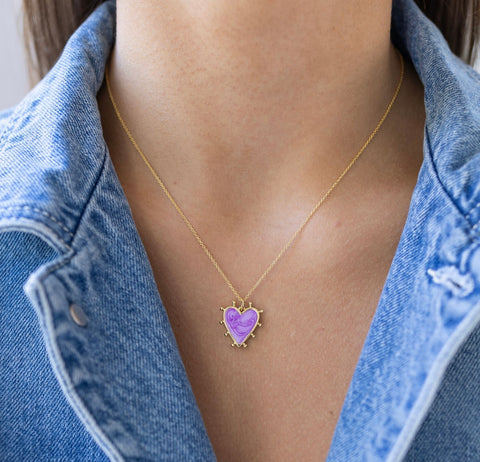 Picture of a fine gold chain with a purple heart pendant with gold edging.