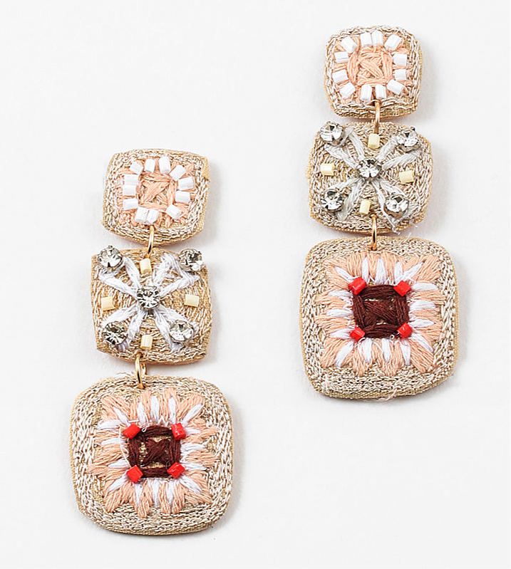 A set of dangle earrings with three sections. Top square is woven in beige with white beads, the second is a beige woven square with white string and clear stones and the third section is a woven square with beige, white and brown strings and pink beads.