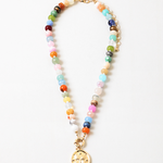 Multicolor bead necklace with a large central clasp and a butterfly disc pendant.