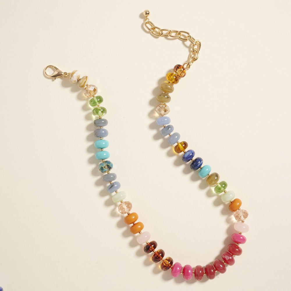 Multicolored beaded necklace on a beige background