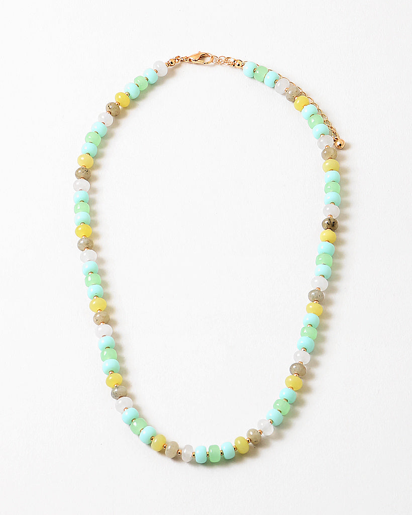 Bead necklace in white, greens, yellows and beige.