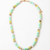 Bead necklace in white, greens, yellows and beige.