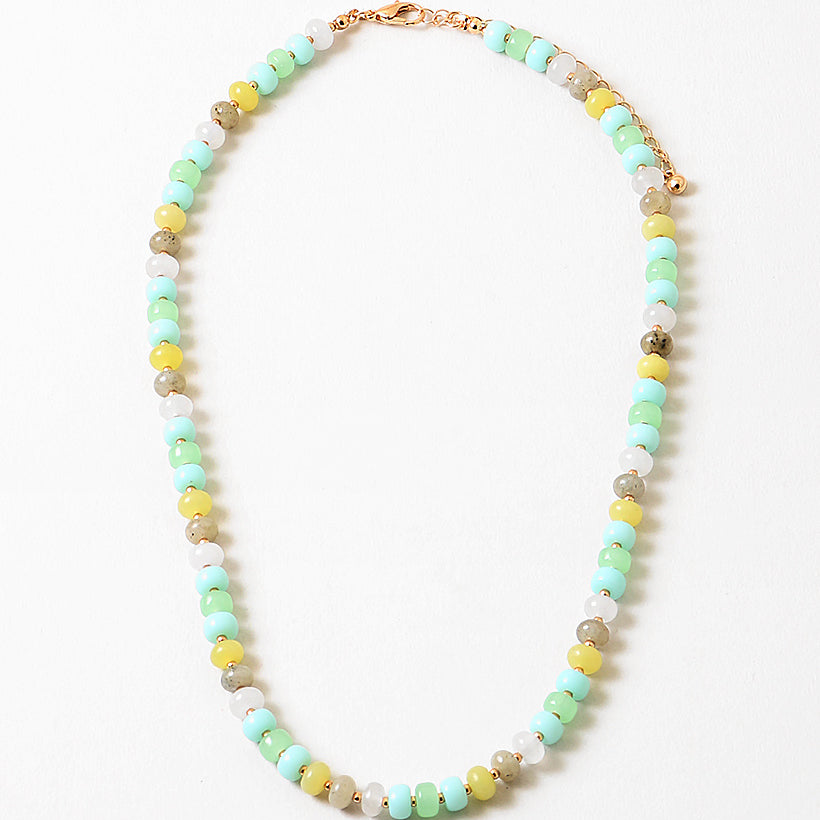 Bead necklace in white, greens, yellows and beige.